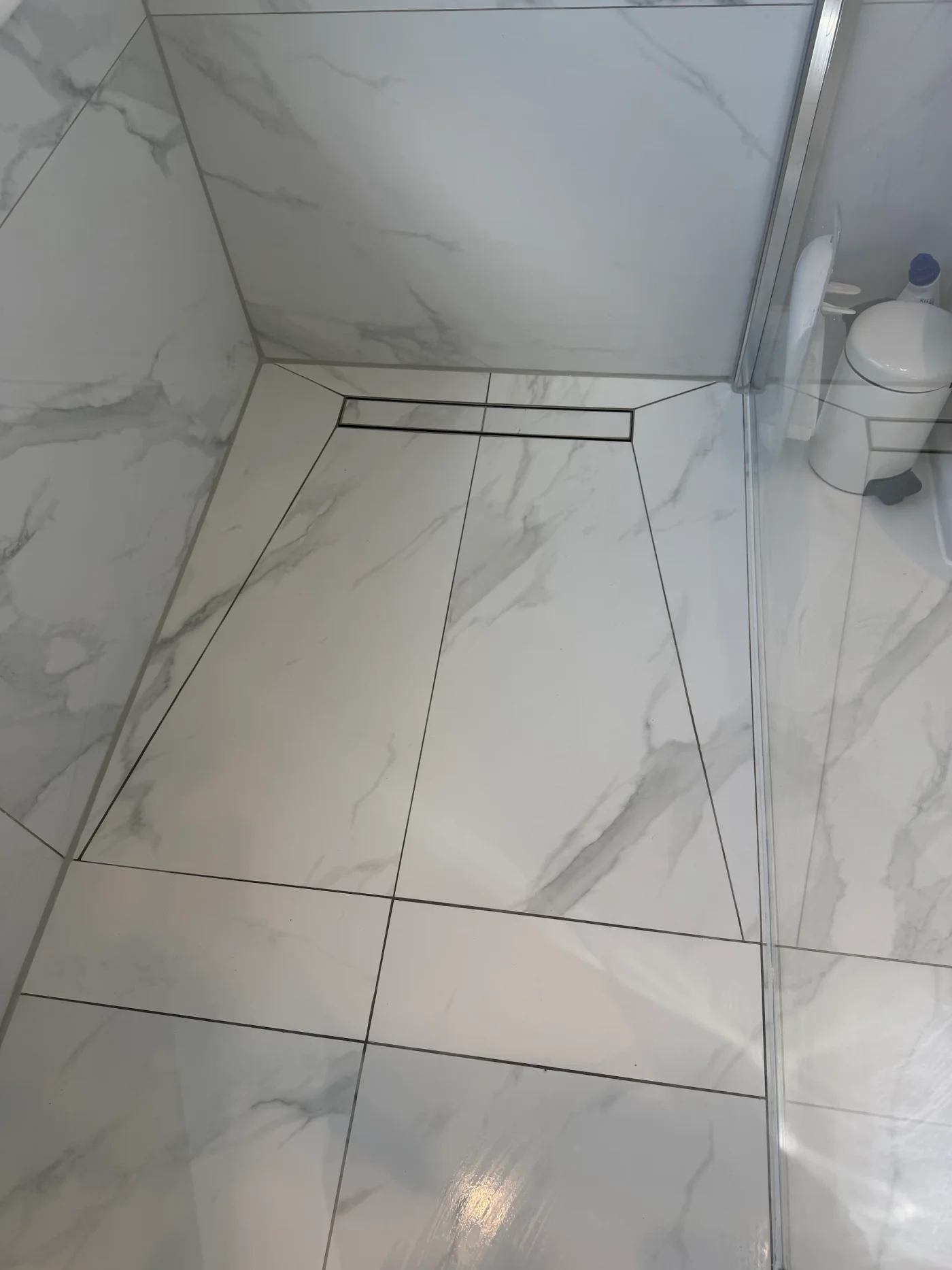 Finished marble-effect shower floor and linear drain