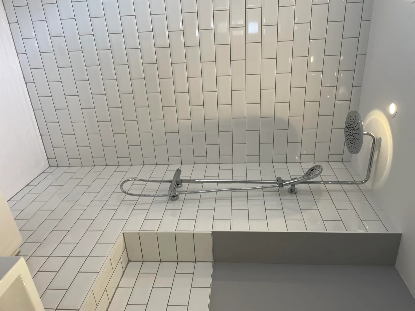 Tiled shower bench and white metro walls